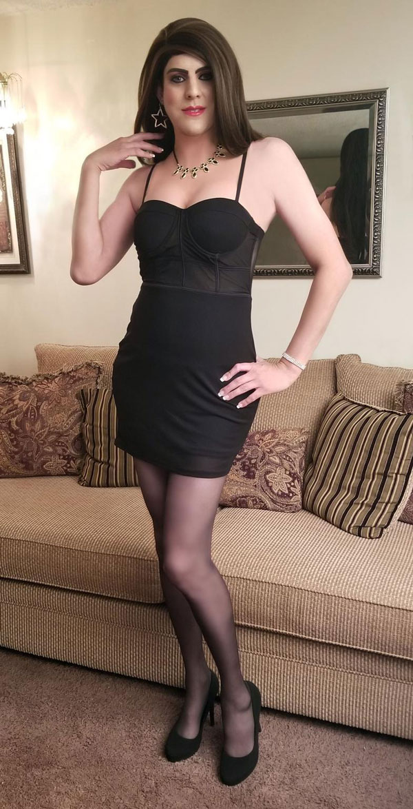 Emily crossdressing in black dress and high heels