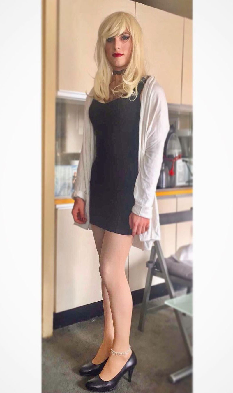 Beautiful crossdresser in black dress and heels